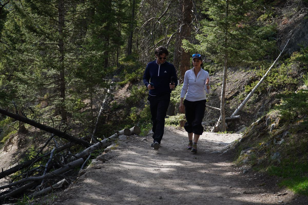 Lisette Oropesa and Nolan Kehler walk in Banff for an interview