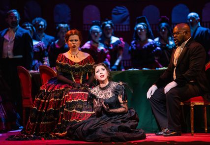 Lisette Oropesa as Violetta Valery, Stephanie Wake-Edwards as Flora Bervoix and Blaise Malaba as Doctor Grenvil in La traviata at Royal Opera House